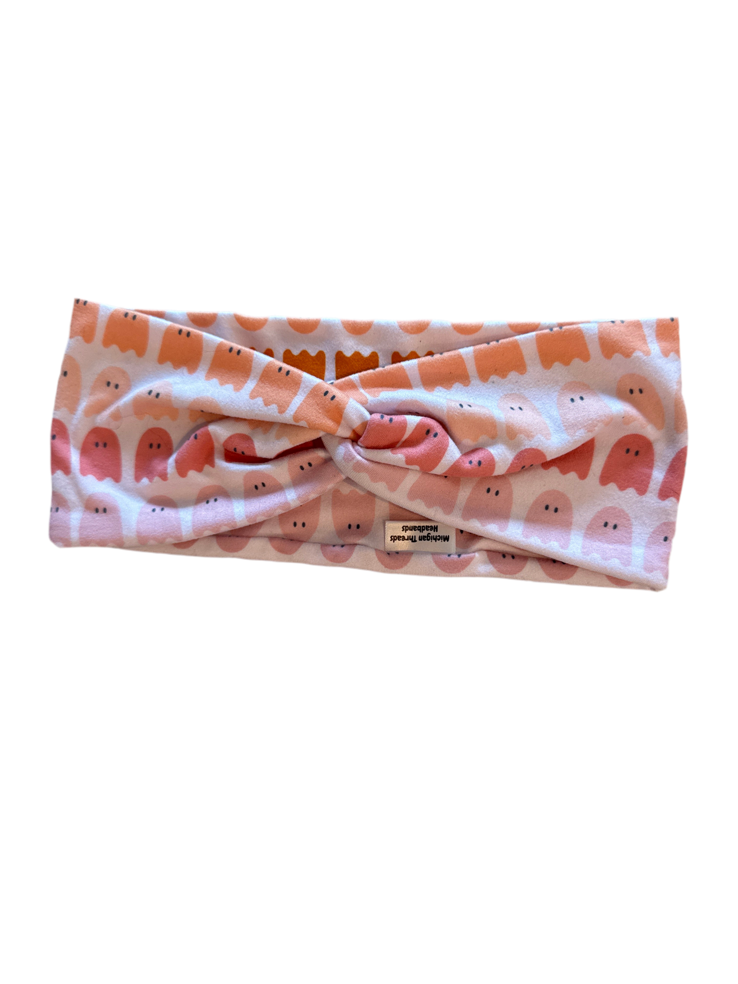Headband with a pattern of small figures on a white background