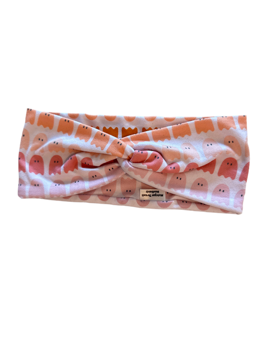 Headband with a pattern of small figures on a white background