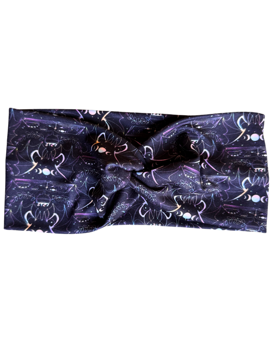 Headband with cat and moon phase pattern on a white background