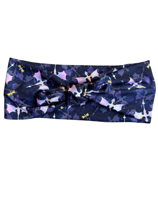 Navy headband with abstract pink and yellow pattern on a white background