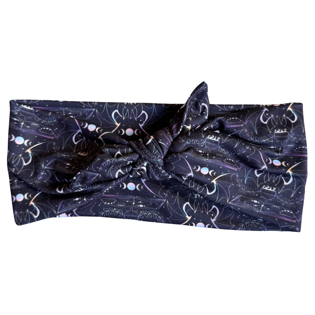Navy blue headband with white cat pattern on a white background