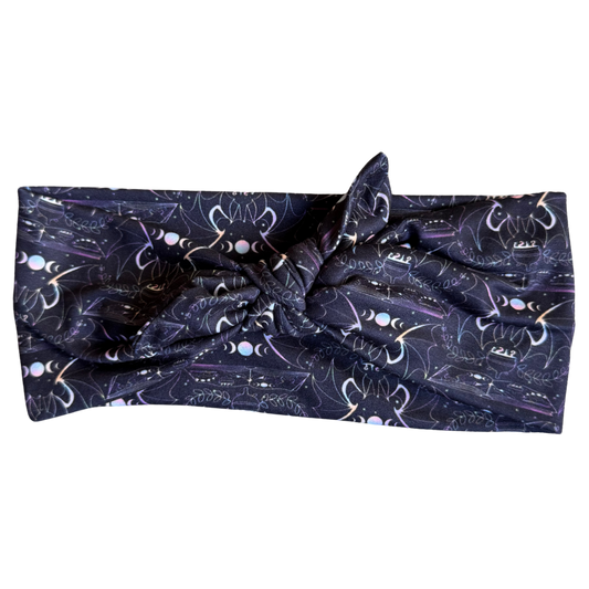 Navy blue headband with white cat pattern on a white background