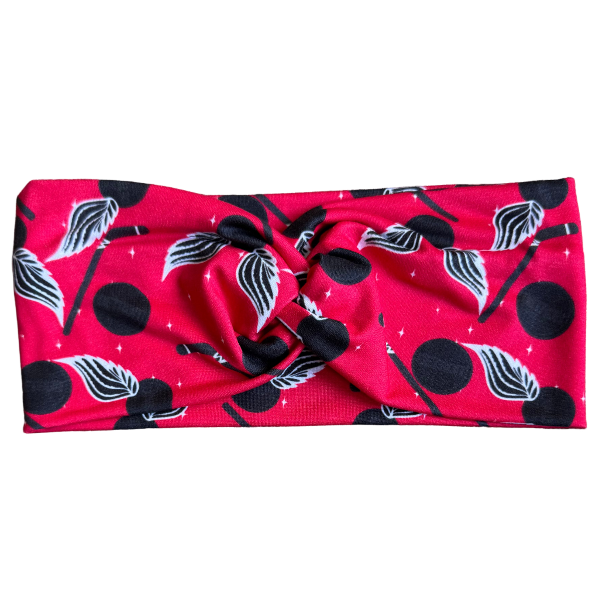 Red headband with black and white patterns on a gray textured background