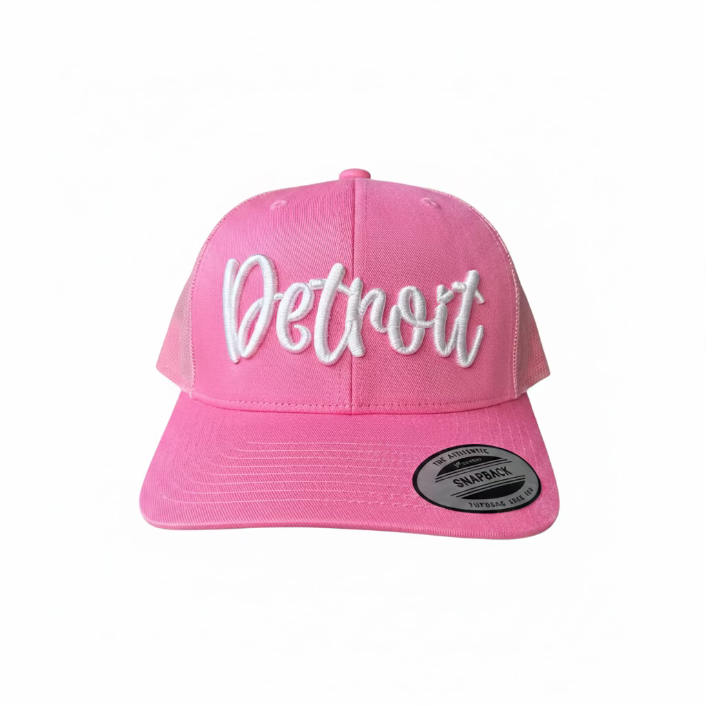 Pink trucker hat with white 3D puff Detroit script across the front panel.