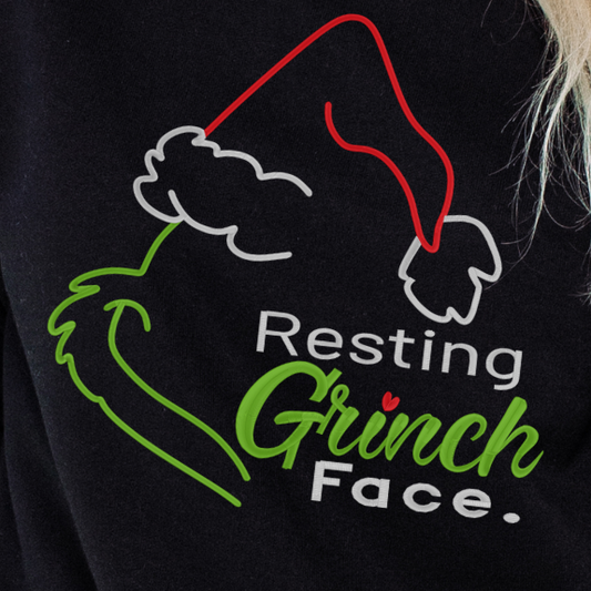Black sweatshirt with 'Resting Grinch Face' design on a person wearing it.