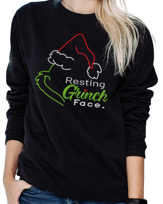 Black sweatshirt with 'Resting Grinch Face' design on a person wearing it.